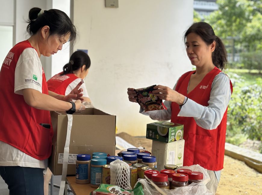 Corporate volunteers from BNP Paribas sorting food at a food donation drive