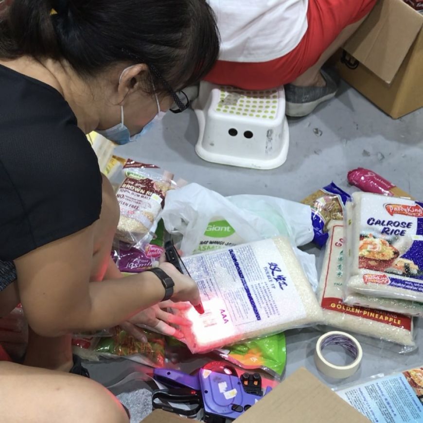 Food from the Heart volunteer sorting food donations with the barcode scanner